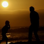 Father and son at the beach silhouettes image