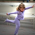 Little girl dancing in the park