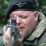 Man with a gun aiming through a gun scope